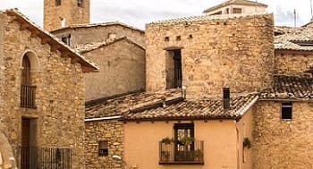casas antiguas de color ocre con tejados de teja clasica de barro ventanas puertas cielo